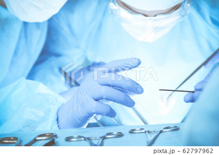 Close-up of medical team performing operation. Group of surgeons at work are busy of patient. Medicine, veterinary or healthcare and emergency in hospital 62797962