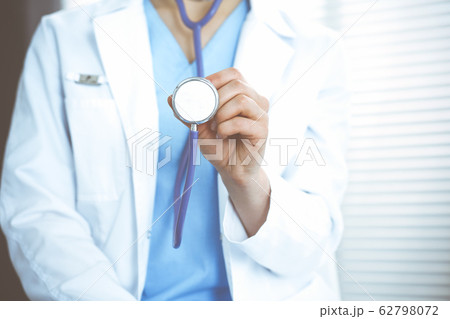 Unknown doctor woman holds stethoscope head, close-up. Physician ready to examine and help patient. Helping and insurance in health care, best treatment and medicine concept 62798072