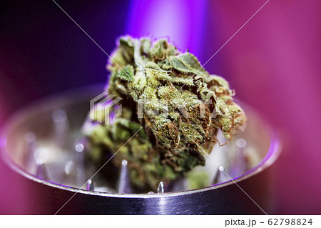 Metal grinder with marijuana, isolated on a black Metal grinder with marijuana, isolated on a black 62798824
