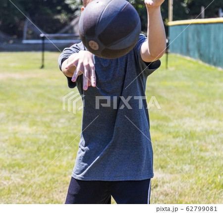 Teenager throwing medicine ball 62799081