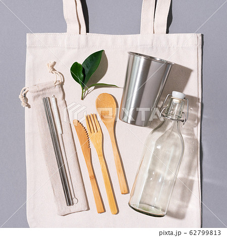 Fabric bags, glass jars, metal straws, bamboo cutlery on grey background with copy space. Eco friendly and reuse concept. Top view. Flat lay. Zero waste concept 62799813