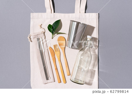 Zero waste concept. Textile eco bags, glass jars and bamboo cutlery on grey background with copy space. Eco friendly and reuse concept. Top view. Flat lay 62799814