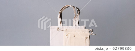 Canvas tote bag canvas and linen fabric bags with drawstring on grey background with copy space. Top view. Zero waste, plastic free concept. Eco friendly shopper. 62799830