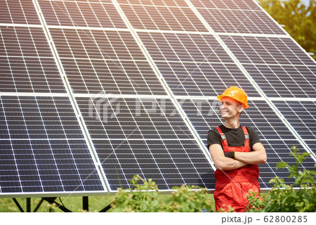 Proud young engineer smiles satisfied with his successful work with his arms crossed. 62800285