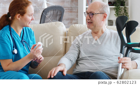 In retirement home nurse is talking with elderly man about drugs dosage In retirement home nurse is talking with elderly man about drugs dosage 62802123