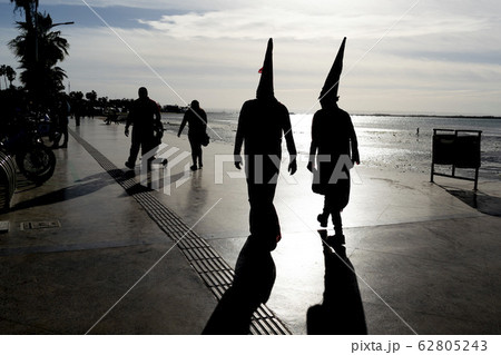 Ku Klux Klan Carnival dressed people silhouette 62805243