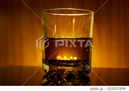 Glass with whisky on a fiery background 62805996