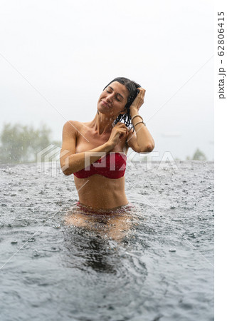 Woman in a bikini relaxing in the open air Woman in a bikini relaxing in the open air 62806415