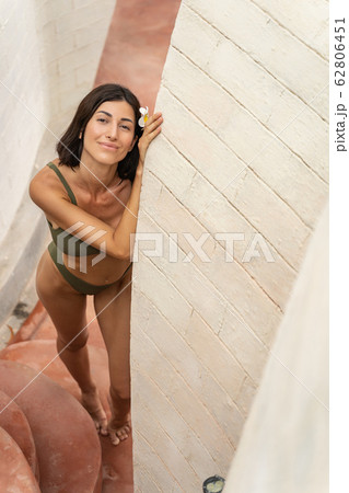 Joyful barefoot Caucasian lady standing on the stone steps Joyful barefoot Caucasian lady standing on the stone steps 62806451