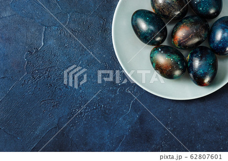 Blue Easter eggs on dark blue background 62807601