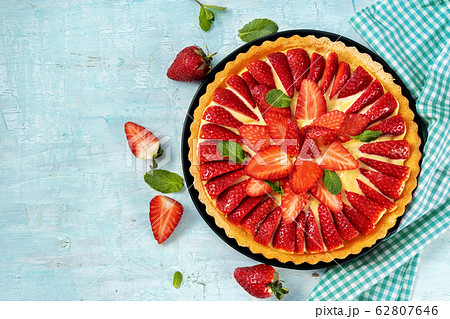 Top view of strawberry cake on light mint 62807646