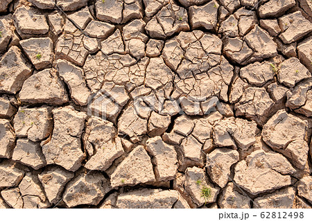 Dry soil results from lack of water.Global warming 62812498