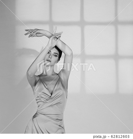 Beautiful woman pose in studio in classic dress Beautiful woman pose in studio in classic dress 62812603