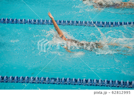 Swimming athlete girl with backstroke during 62812995