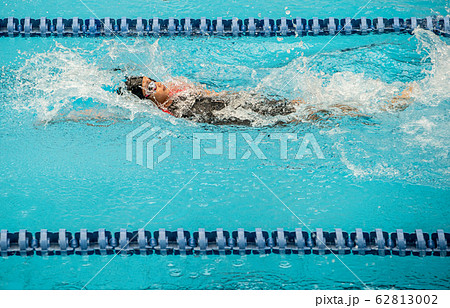 Swimming athlete girl with backstroke in competition 62813002