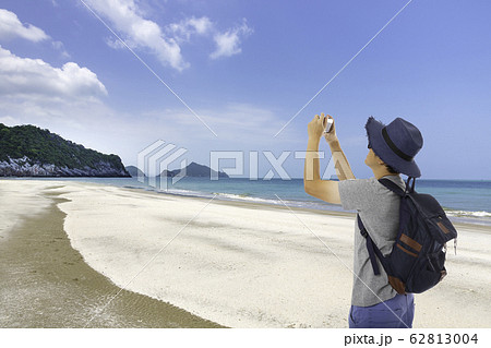 Asian tourist man taking photo on the beach 62813004