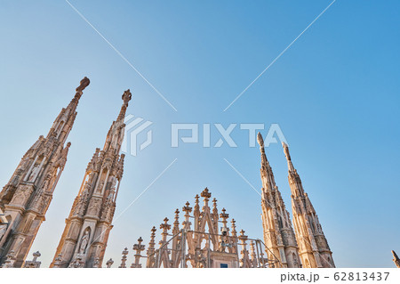 Amazing view of old Gothic spires. Milan Cathedral roof on sunny day, Italy. Milan Cathedral or Duomo di Milano is top tourist attraction of Milan. Amazing view of old Gothic spires. Milan Cathedral roof on sunny day, Italy. Milan Cathedral or Duomo di Milano is top tourist attraction of Milan. 62813437