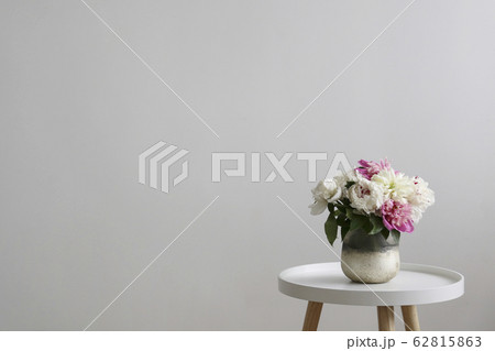 Beautiful peony flowers closeup over textured background with a lot of copy space for text. International women's mother's valentine's first spring day. Close up, top view, backdrop, flat lay. Beautiful peony flowers closeup over textured background with a lot of copy space for text. International women's mother's valentine's first spring day. Close up, top view, backdrop, flat lay. 62815863