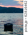 small boat in the water in the sunrise 62816462