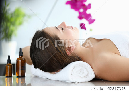 Girl lies in massage parlor, near aromatic oils 62817393