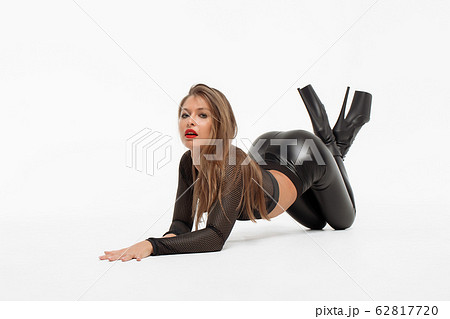 Attractive charming woman in leather suit and high Attractive charming woman in leather suit and high 62817720