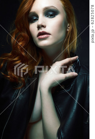 Beautiful young Woman with Red Hair in leather 62825078