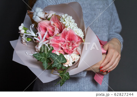 Girl holds in her hands original bouquet in 62827244