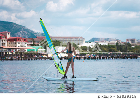 Young slim woman with sports figure learns to 62829318