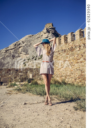 Young woman in fashionable clothes a summer dress Young woman in fashionable clothes a summer dress 62829340