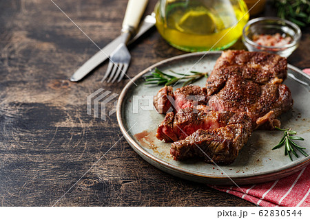 Two beef steak on dark gray background 62830544