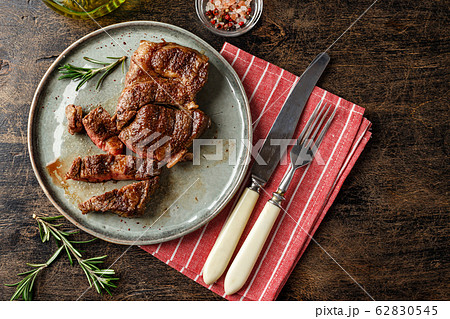Two beef steak on dark gray background Two beef steak on dark gray background 62830545