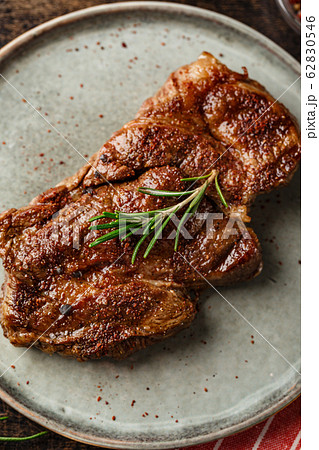 Two beef steak on dark gray background 62830546
