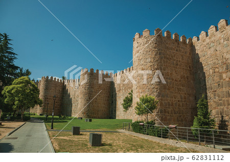 Several towers on the city wall and green garden in Avila Several towers on the city wall and green garden in Avila 62831112
