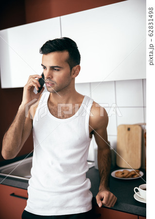 Handsome man talking on smartphone in the morning Handsome man talking on smartphone in the morning 62831498