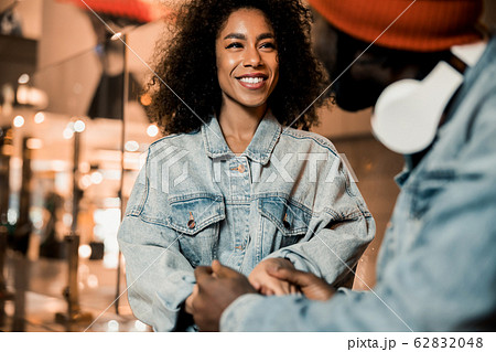 Pretty smiling lady looking at guy in the city Pretty smiling lady looking at guy in the city 62832048