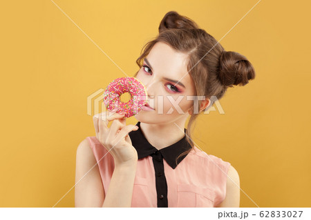 Cute fashion model woman with donut on vivid Cute fashion model woman with donut on vivid 62833027