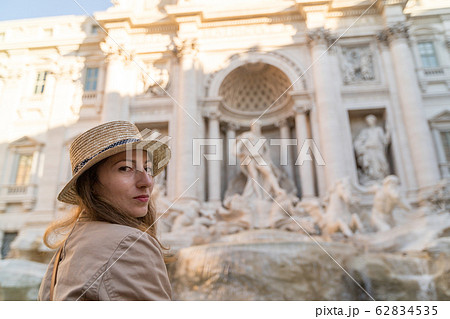 Young woman looking to the Fountain of Trevi during her trip in Rome, Italy. Girl enjoy her european vacation Young woman looking to the Fountain of Trevi during her trip in Rome, Italy. Girl enjoy her european vacation 62834535