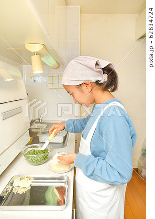 キッチンで料理をする女の子 キッチンで料理をする女の子 62834724