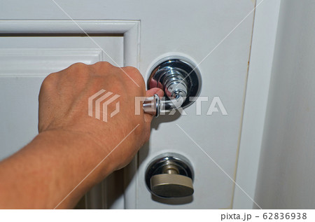 Hand on a door handle Hand on a door handle 62836938