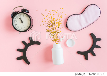 White bottle, two pills, gold stars confetti, 62840323