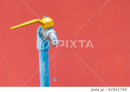 water drop faucet on brick wall background 62841799