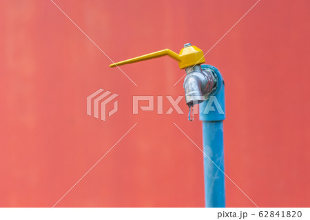 water drop faucet on brick wall background 62841820