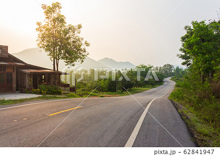 Curve Asphalt Road Through Green Forest On The 62841947