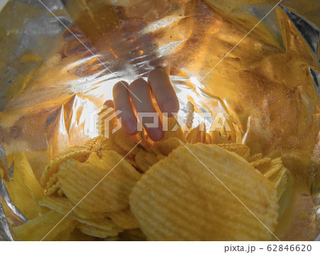 Taking snack chips inside package Taking snack chips inside package 62846620
