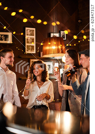 Happy group of friends at the bar having drinks. Happy group of friends at the bar having drinks. 62847317