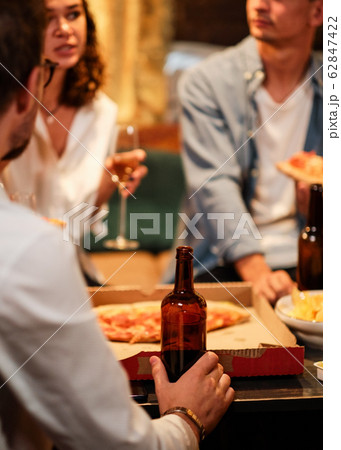 Happy group of friends at the bar having drinks. 62847422