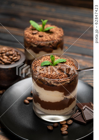 Classic tiramisu dessert in a glass cup on wooden background 62847423
