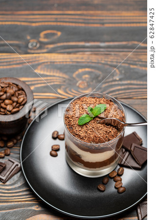 Classic tiramisu dessert in a glass cup on wooden background Classic tiramisu dessert in a glass cup on wooden background 62847425