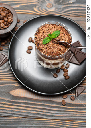 Classic tiramisu dessert in a glass cup on wooden background Classic tiramisu dessert in a glass cup on wooden background 62847426