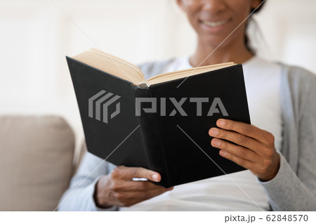 African American woman reading book relaxing at home African American woman reading book relaxing at home 62848570